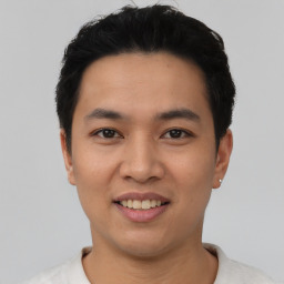 Joyful asian young-adult male with short  black hair and brown eyes