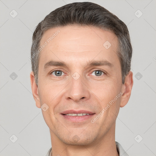 Joyful white adult male with short  brown hair and grey eyes