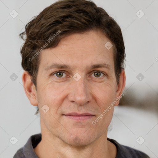 Joyful white adult male with short  brown hair and grey eyes