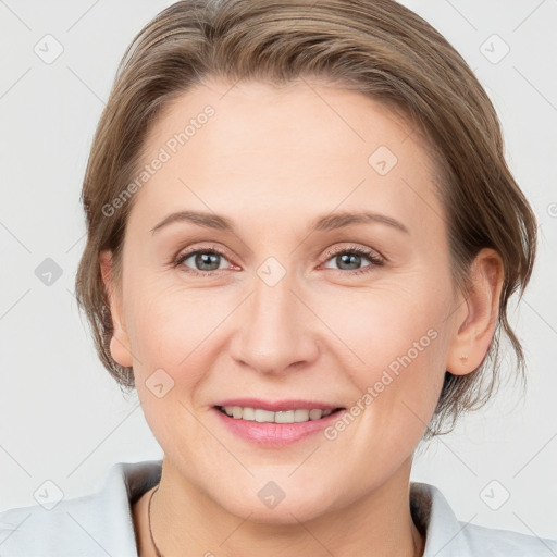 Joyful white adult female with medium  brown hair and grey eyes