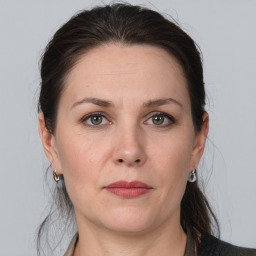 Joyful white adult female with medium  brown hair and grey eyes