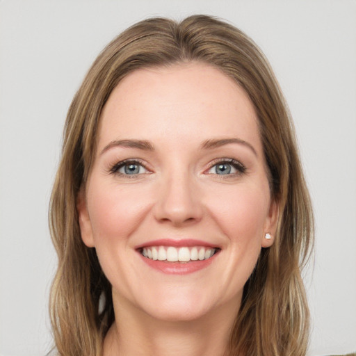 Joyful white young-adult female with medium  brown hair and green eyes