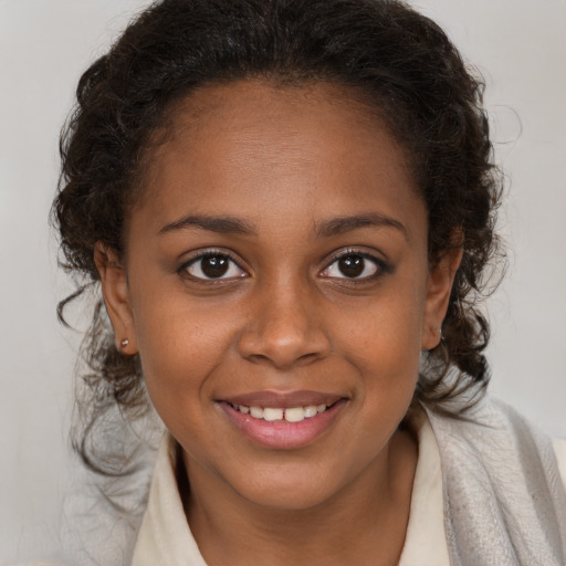 Joyful black young-adult female with medium  brown hair and brown eyes