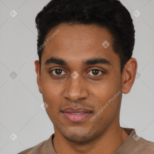 Joyful black young-adult male with short  black hair and brown eyes
