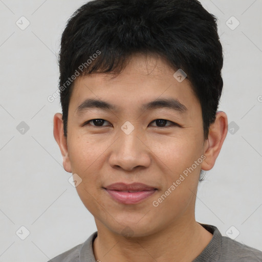 Joyful asian young-adult male with short  black hair and brown eyes