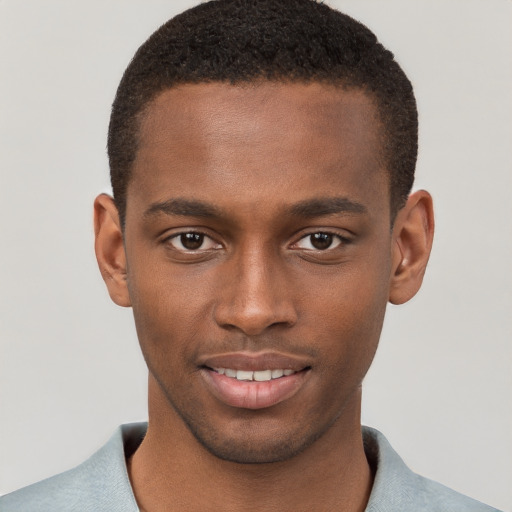 Joyful black young-adult male with short  brown hair and brown eyes