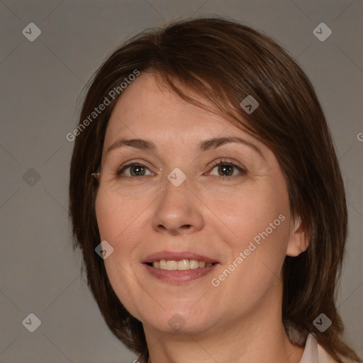 Joyful white adult female with medium  brown hair and brown eyes