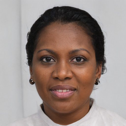Joyful black young-adult female with short  black hair and brown eyes