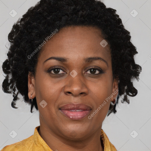 Joyful black adult female with short  brown hair and brown eyes