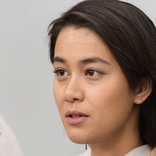 Neutral asian young-adult female with medium  brown hair and brown eyes