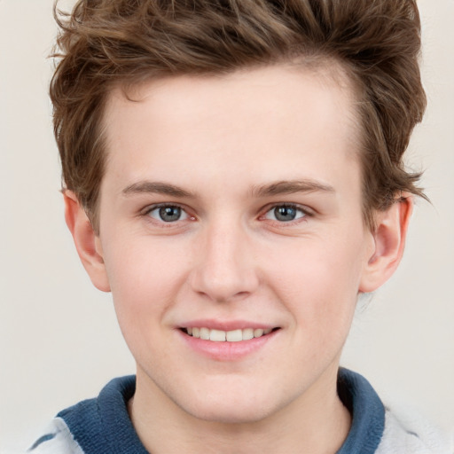 Joyful white child male with short  brown hair and grey eyes