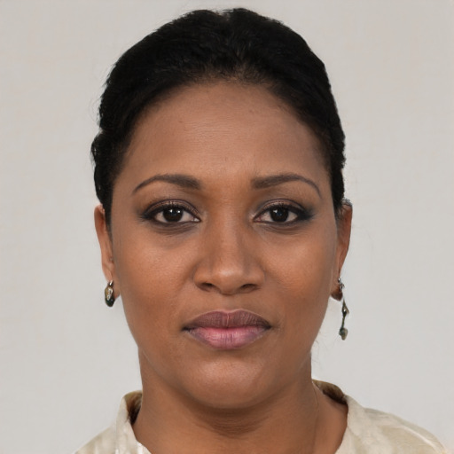 Joyful black young-adult female with short  brown hair and brown eyes