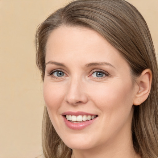 Joyful white young-adult female with long  brown hair and grey eyes