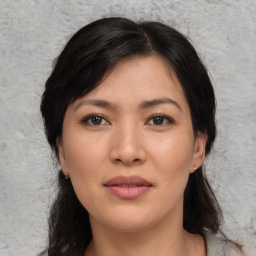Joyful asian young-adult female with medium  brown hair and brown eyes