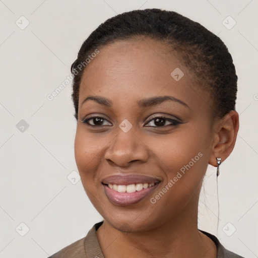 Joyful black young-adult female with short  brown hair and brown eyes