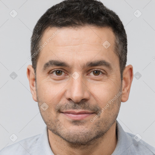 Joyful white adult male with short  brown hair and brown eyes