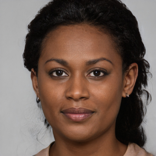 Joyful black young-adult female with medium  black hair and brown eyes