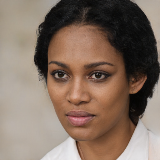 Joyful black young-adult female with medium  black hair and brown eyes