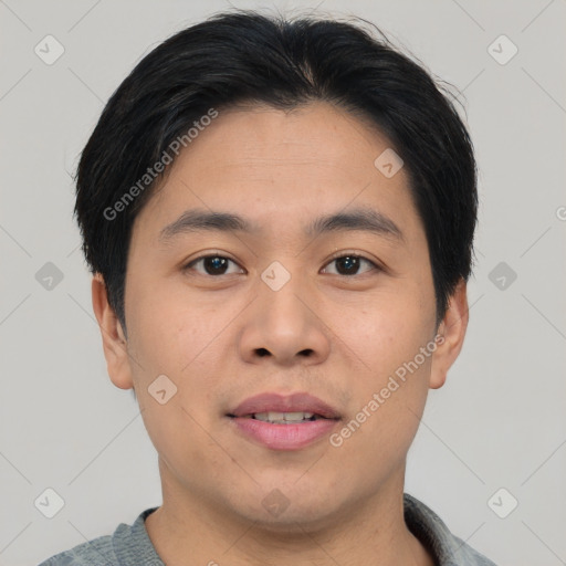 Joyful asian young-adult male with short  brown hair and brown eyes