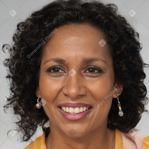 Joyful black adult female with long  brown hair and brown eyes