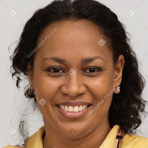 Joyful black adult female with medium  brown hair and brown eyes