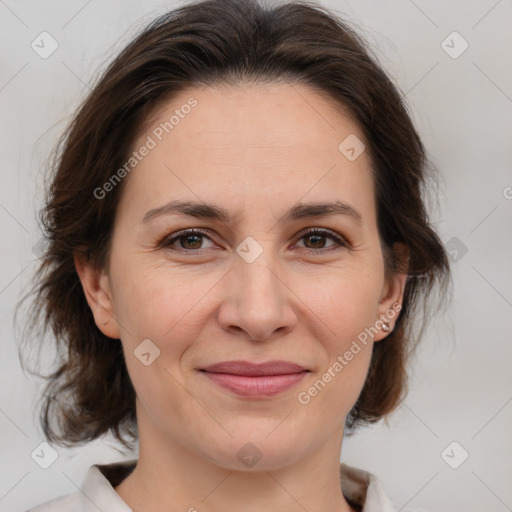 Joyful white adult female with medium  brown hair and brown eyes