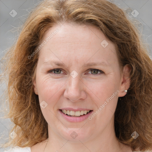 Joyful white young-adult female with medium  brown hair and blue eyes