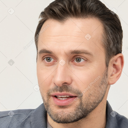 Joyful white adult male with short  brown hair and brown eyes