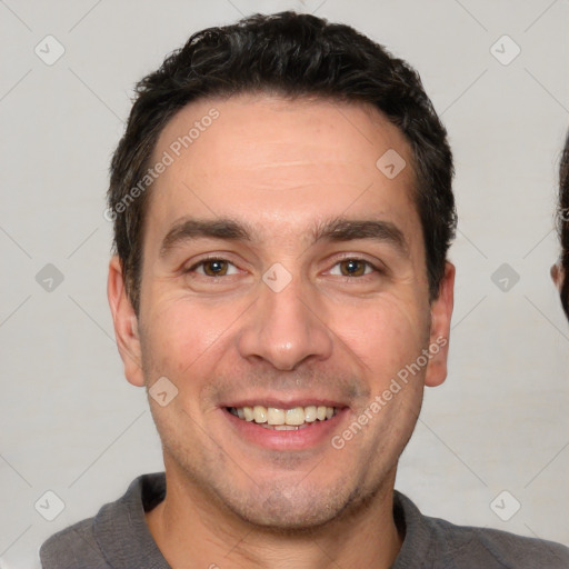 Joyful white adult male with short  black hair and brown eyes