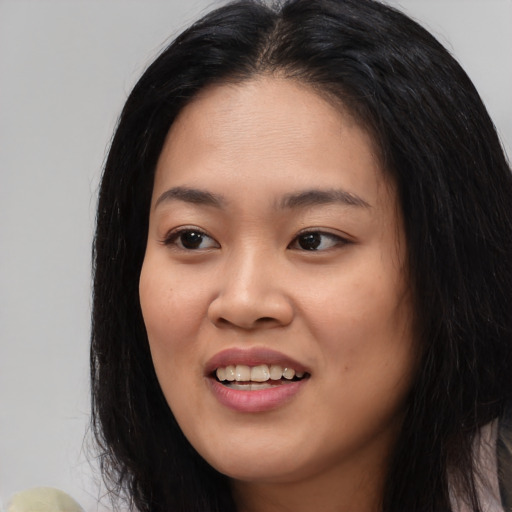 Joyful white young-adult female with long  black hair and brown eyes