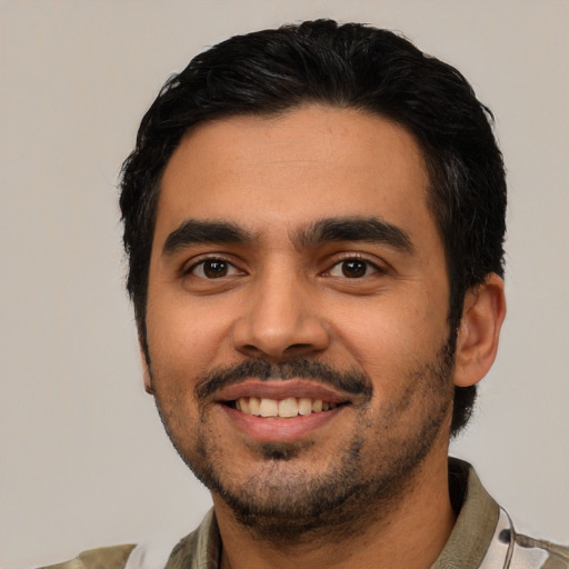 Joyful latino young-adult male with short  black hair and brown eyes