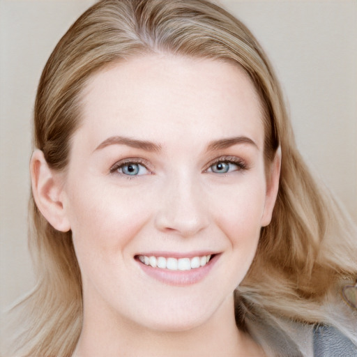 Joyful white young-adult female with long  brown hair and blue eyes