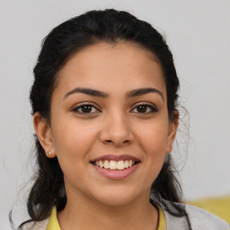 Joyful latino young-adult female with medium  brown hair and brown eyes