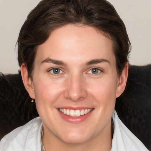 Joyful white adult female with medium  brown hair and grey eyes