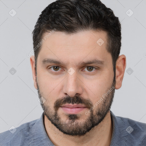 Neutral white young-adult male with short  black hair and brown eyes