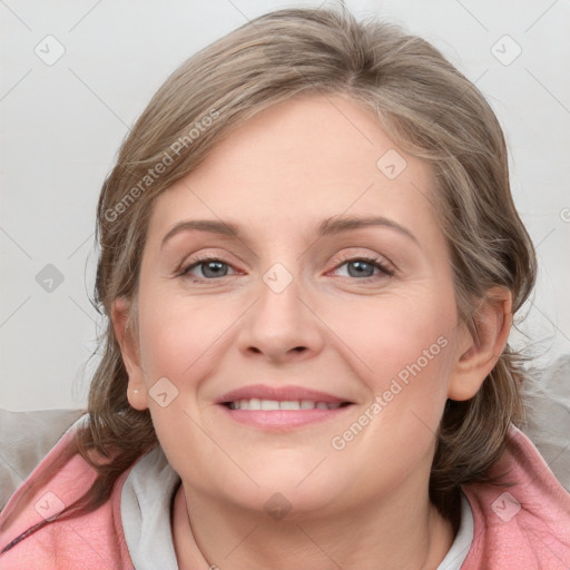 Joyful white young-adult female with medium  brown hair and blue eyes