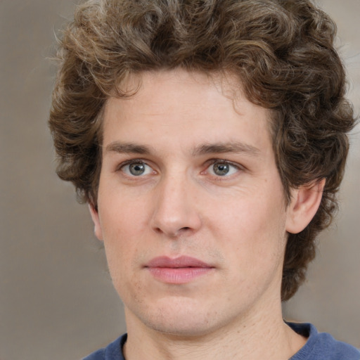 Joyful white young-adult male with medium  brown hair and grey eyes