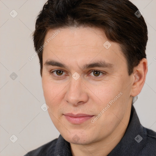 Joyful white adult male with short  brown hair and brown eyes