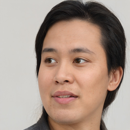 Joyful asian young-adult male with medium  brown hair and brown eyes