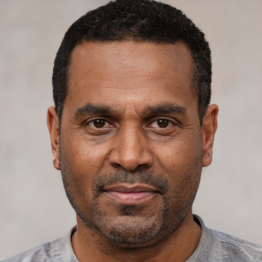 Neutral latino adult male with short  black hair and brown eyes