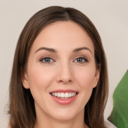 Joyful white young-adult female with long  brown hair and green eyes