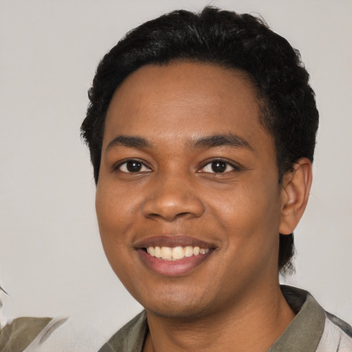 Joyful black young-adult male with short  black hair and brown eyes