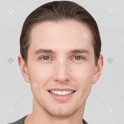 Joyful white young-adult male with short  brown hair and grey eyes