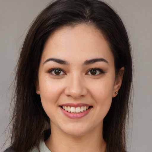 Joyful white young-adult female with long  brown hair and brown eyes
