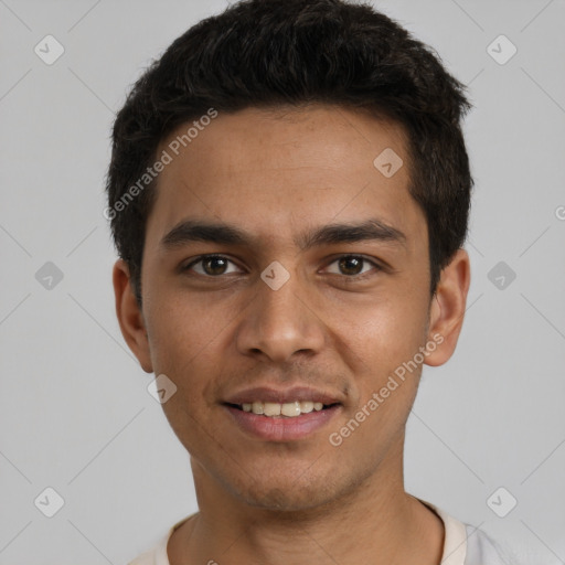 Joyful white young-adult male with short  black hair and brown eyes