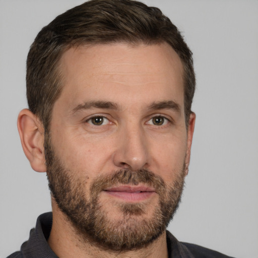 Joyful white adult male with short  brown hair and brown eyes