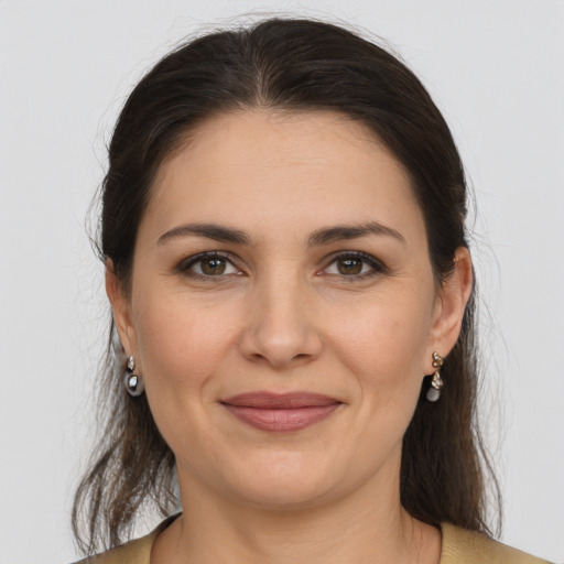 Joyful white young-adult female with medium  brown hair and brown eyes