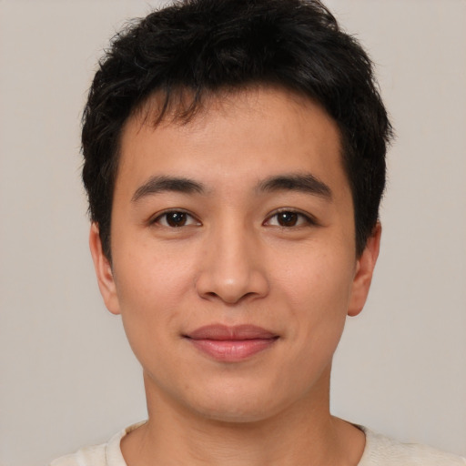 Joyful asian young-adult male with short  brown hair and brown eyes