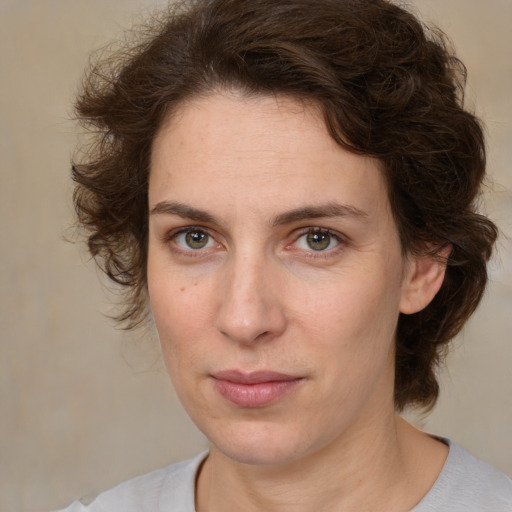 Joyful white young-adult female with medium  brown hair and green eyes