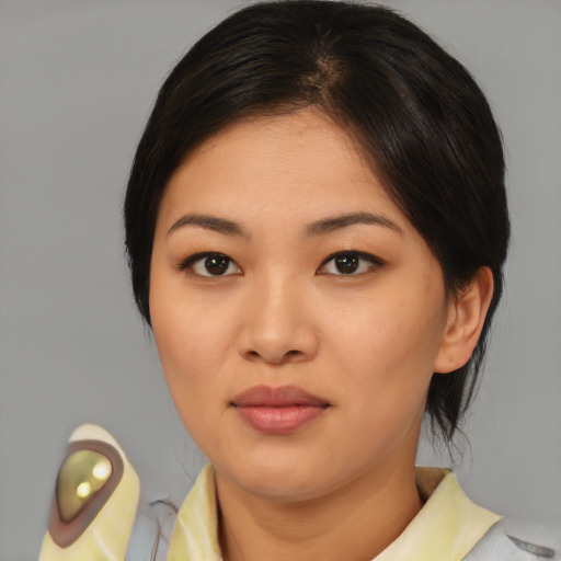 Joyful asian young-adult female with medium  brown hair and brown eyes